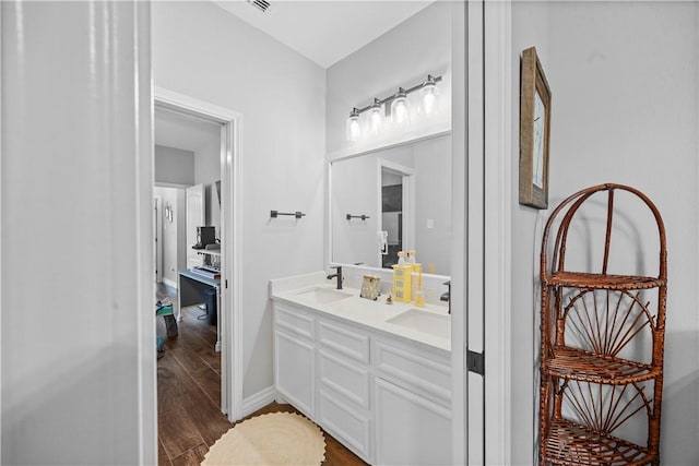 7746 Krypton Dr, Corpus Christi, TX 78414 - bathroom featuring wood finished floors, double vanity, and baseboards