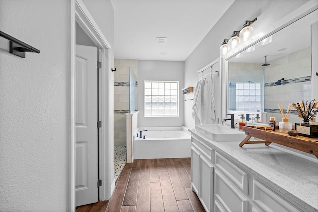 7746 Krypton Dr, Corpus Christi, TX 78414 - bathroom with hardwood / wood-style flooring, a stall shower, a bath, and vanity