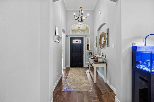 7746 Krypton Dr, Corpus Christi, TX 78414 - entryway featuring a chandelier, dark wood finished floors, ornamental molding, baseboards, and a towering ceiling