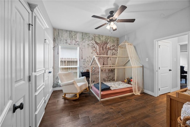 7746 Krypton Dr, Corpus Christi, TX 78414 - bedroom featuring baseboards, wallpapered walls, wood finished floors, an accent wall, and a ceiling fan