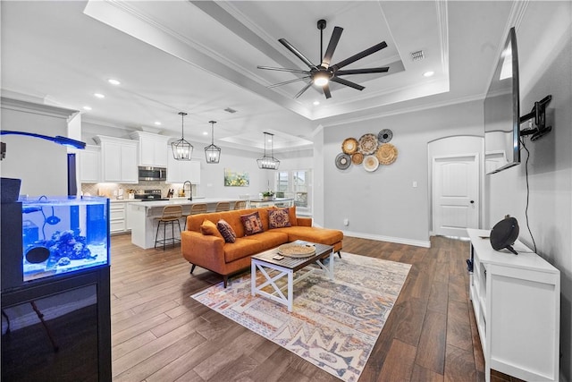 7746 Krypton Dr, Corpus Christi, TX 78414 - living area featuring a raised ceiling, a ceiling fan, crown molding, dark wood finished floors, and recessed lighting