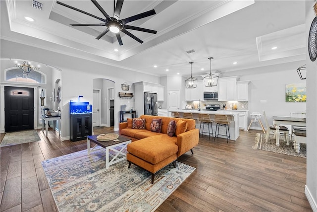 7746 Krypton Dr, Corpus Christi, TX 78414 - living area featuring a raised ceiling, dark wood-style flooring, crown molding, a ceiling fan, and recessed lighting