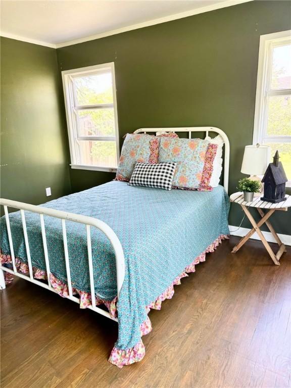 601 E Joyce St, Bishop, TX 78343 - bedroom featuring wood finished floors and crown molding