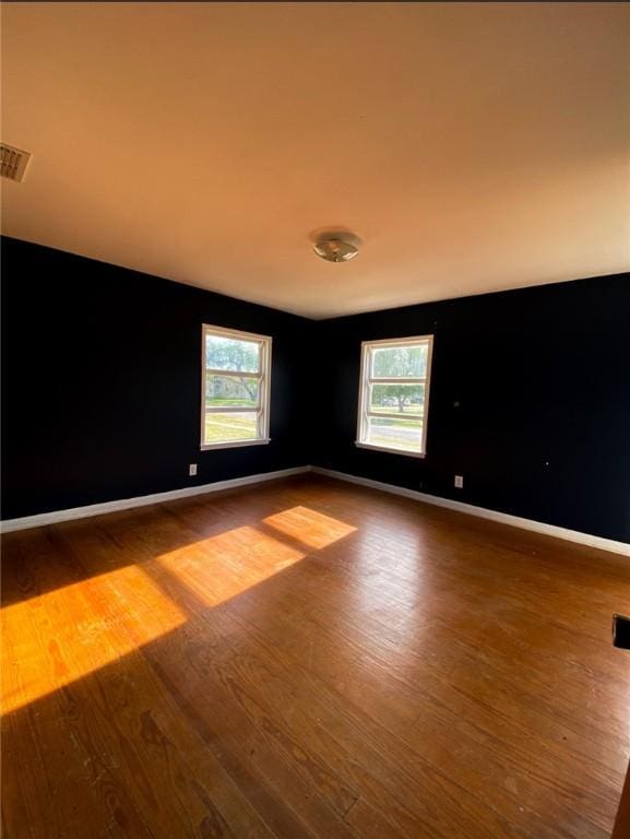 601 E Joyce St, Bishop, TX 78343 - empty room with wood finished floors and healthy amount of natural light
