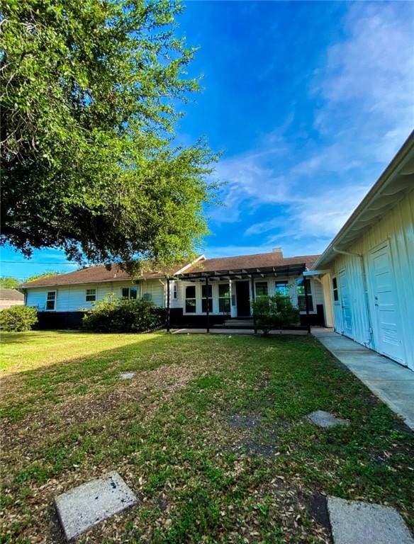 601 E Joyce St, Bishop, TX 78343 - view of front of property with board and batten siding and a front yard