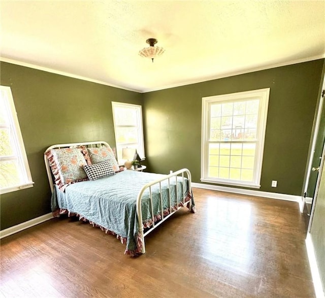 601 E Joyce St, Bishop, TX 78343 - bedroom featuring wood finished floors, multiple windows, and ornamental molding