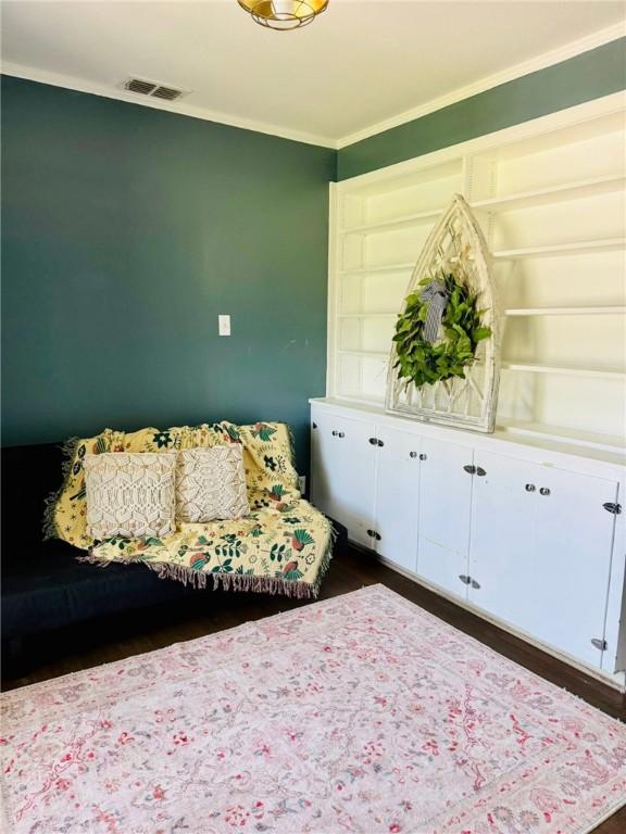 601 E Joyce St, Bishop, TX 78343 - living area featuring crown molding and dark wood-style floors