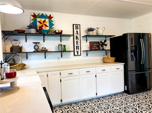 601 E Joyce St, Bishop, TX 78343 - kitchen featuring refrigerator with ice dispenser, open shelves, white cabinetry, and light countertops