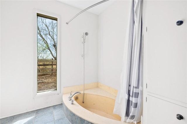 bathroom featuring a shower with curtain, a bathtub, and a wealth of natural light