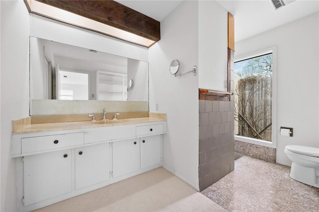 bathroom featuring visible vents, vanity, and toilet