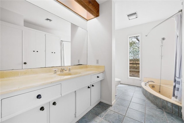 full bath with toilet, tiled bath, visible vents, and vanity