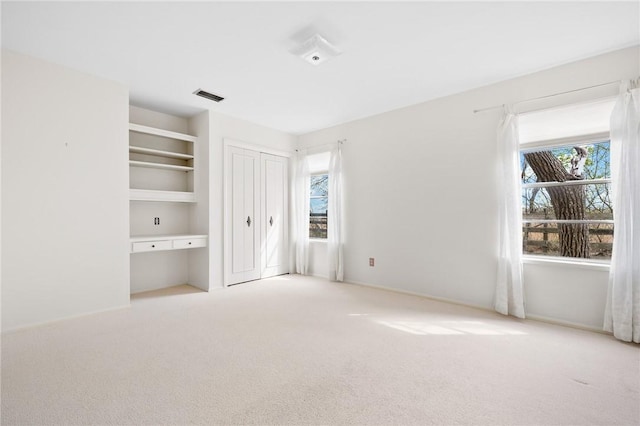 unfurnished bedroom with carpet and visible vents