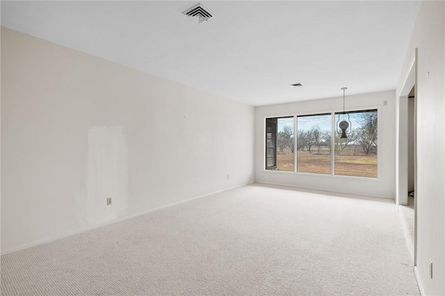 spare room with light carpet and visible vents