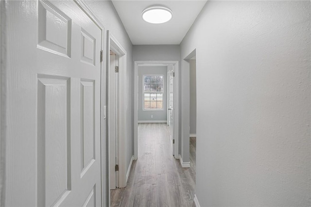 corridor featuring light hardwood / wood-style floors