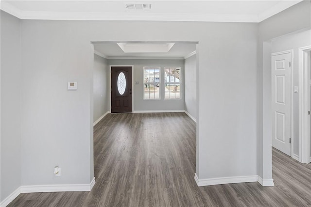 foyer entrance featuring ornamental molding and dark hardwood / wood-style floors