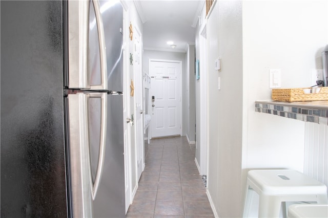 hallway with tile patterned flooring and crown molding