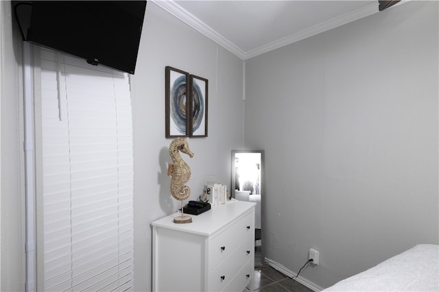 bedroom featuring dark tile patterned flooring and crown molding