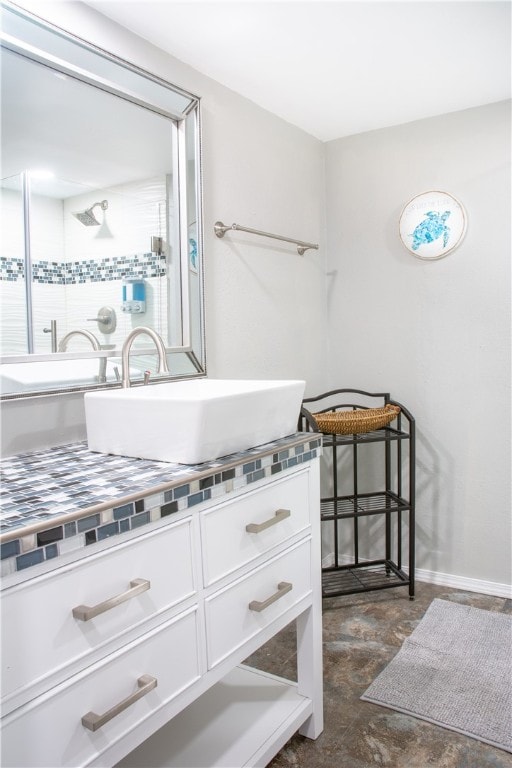 bathroom featuring a shower and vanity