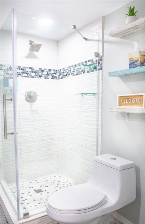 bathroom with tiled shower and toilet