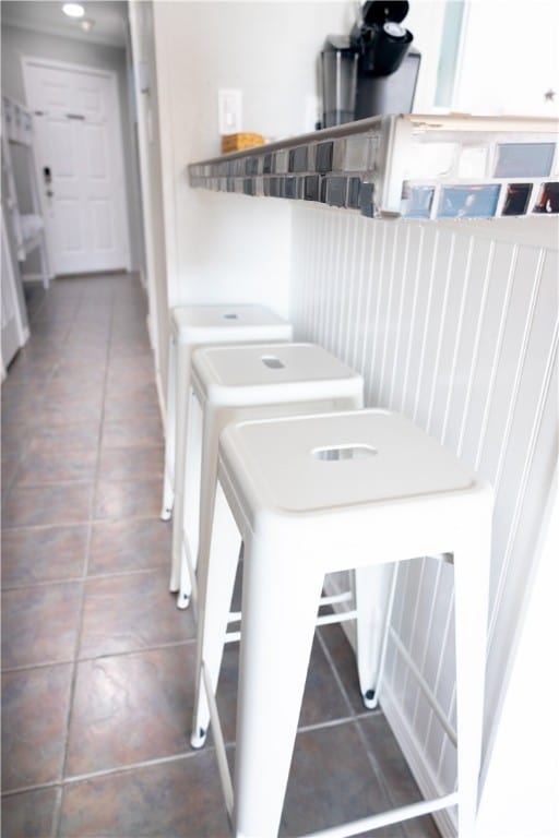 washroom with washer and clothes dryer and dark tile patterned flooring