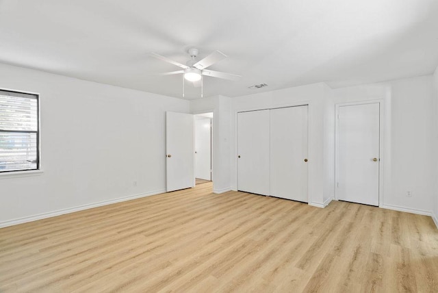2201 Woodcrest Dr, Corpus Christi, TX 78418 - unfurnished bedroom with light wood-style flooring, a ceiling fan, and a closet