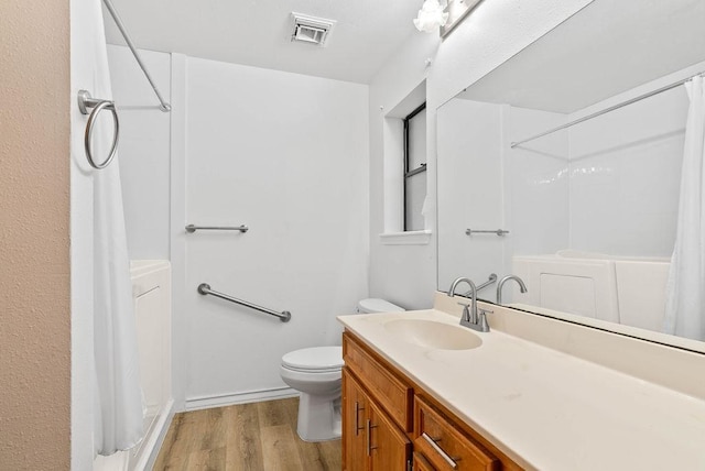 2201 Woodcrest Dr, Corpus Christi, TX 78418 - bathroom with wood finished floors, curtained shower, and vanity