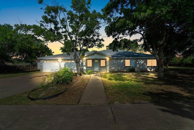 2201 Woodcrest Dr, Corpus Christi, TX 78418 - view of front of home featuring driveway, an attached garage, and a front yard