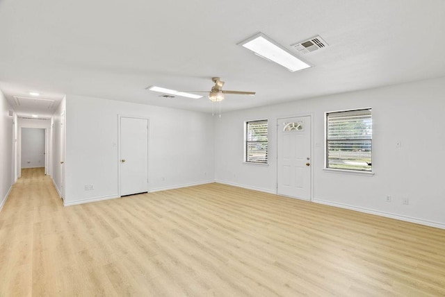 2201 Woodcrest Dr, Corpus Christi, TX 78418 - unfurnished living room with light wood finished floors, attic access, and a ceiling fan