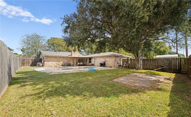 rear view of house with a lawn and a patio