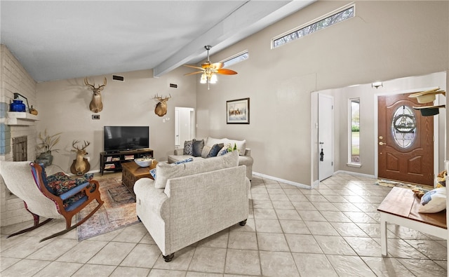 living room with ceiling fan, a fireplace, light tile patterned floors, and lofted ceiling with beams