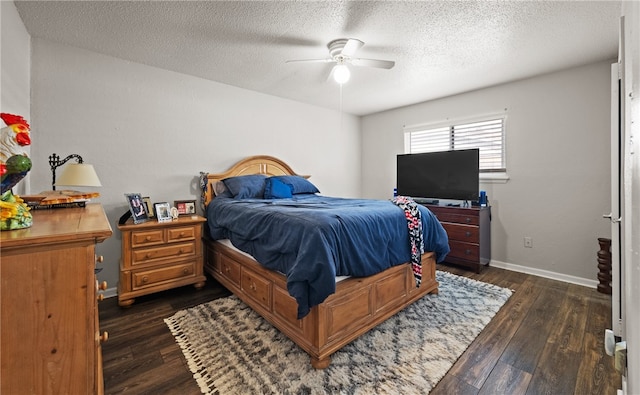 bedroom with a textured ceiling, ceiling fan, and dark hardwood / wood-style floors