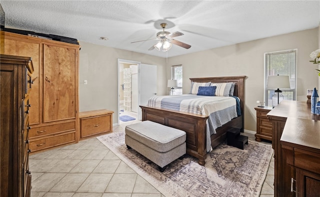 tiled bedroom featuring a textured ceiling, connected bathroom, and ceiling fan