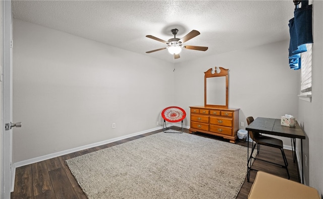 bedroom featuring a textured ceiling, dark hardwood / wood-style floors, and ceiling fan