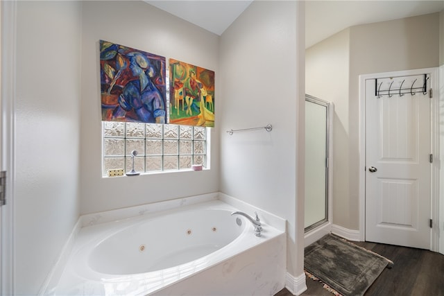 bathroom featuring hardwood / wood-style floors and plus walk in shower