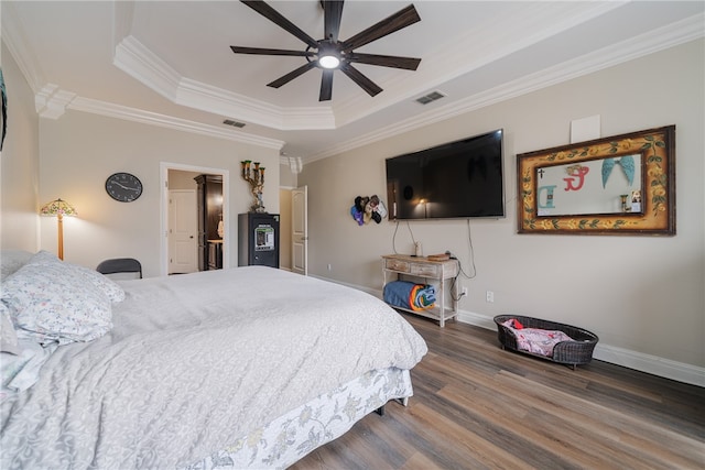 bedroom with dark hardwood / wood-style flooring, a raised ceiling, ceiling fan, and crown molding