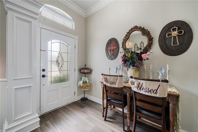 foyer entrance featuring a wealth of natural light, wood-type flooring, and crown molding