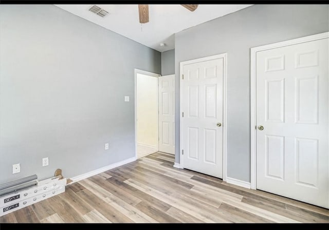 unfurnished bedroom featuring light wood-type flooring and ceiling fan