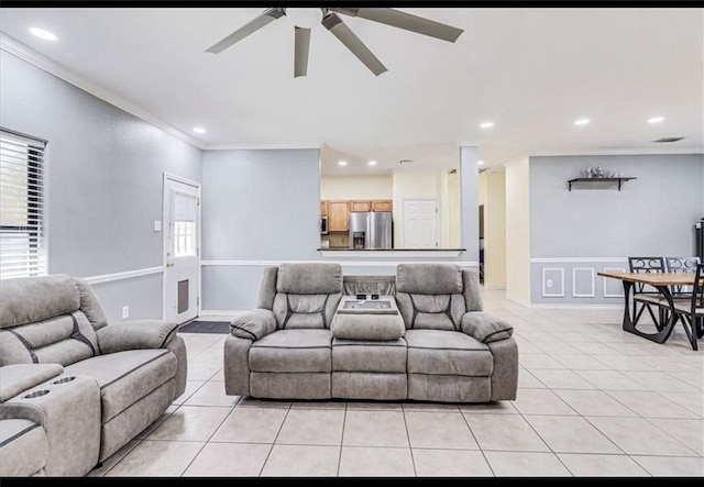 living room featuring light tile patterned floors and crown molding