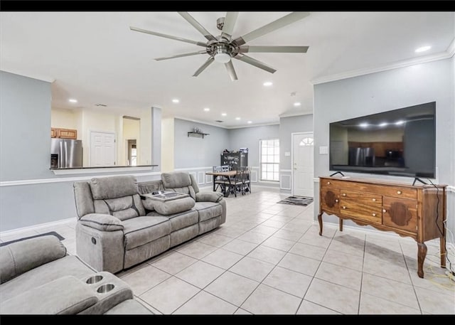 living room with ceiling fan, light tile patterned floors, and ornamental molding