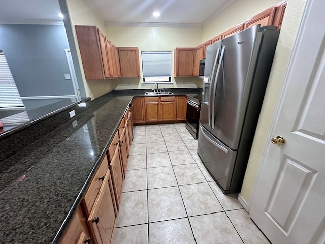 kitchen featuring crown molding, sink, dark stone countertops, light tile patterned floors, and appliances with stainless steel finishes