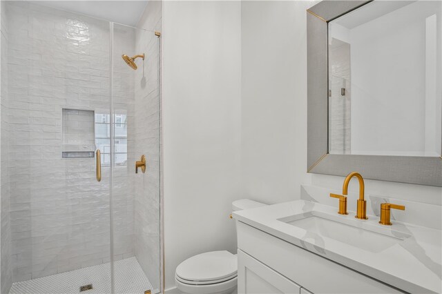 bathroom with vanity, toilet, and an enclosed shower