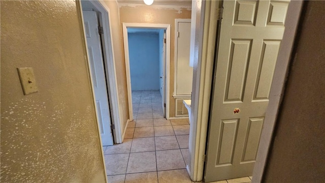 hallway featuring light tile patterned floors