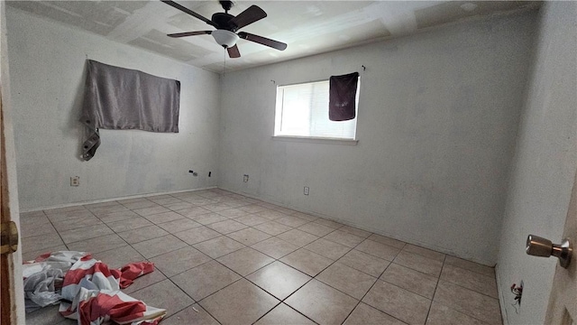 unfurnished room with ceiling fan and light tile patterned flooring