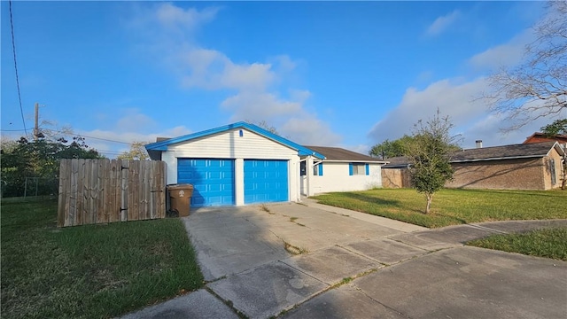 ranch-style home featuring a garage and a front lawn