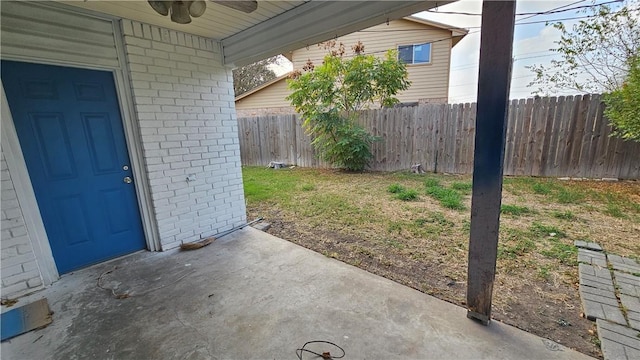 view of yard featuring ceiling fan, a patio, and a fenced backyard