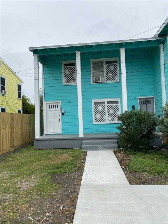 view of front of house featuring fence