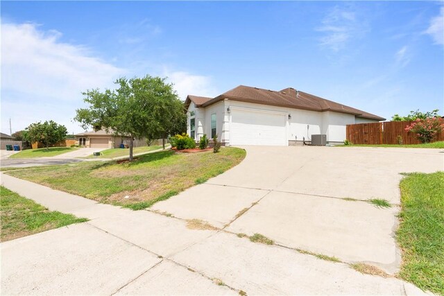 4529 Ballad Tree Dr, Corpus Christi, TX 78410 - view of front of house with driveway, an attached garage, and stucco siding
