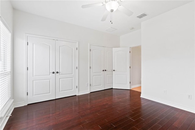 4529 Ballad Tree Dr, Corpus Christi, TX 78410 - unfurnished bedroom with two closets, wood finished floors, and a ceiling fan