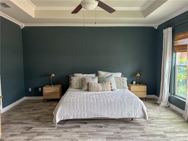 15114 Barataria Dr, Corpus Christi, TX 78418 - bedroom with a raised ceiling, wood finished floors, crown molding, and ceiling fan