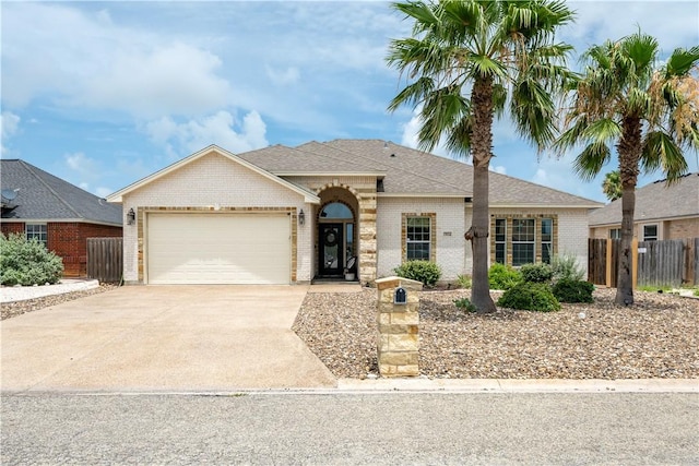15114 Barataria Dr, Corpus Christi, TX 78418 - ranch-style home featuring brick siding, an attached garage, concrete driveway, and roof with shingles